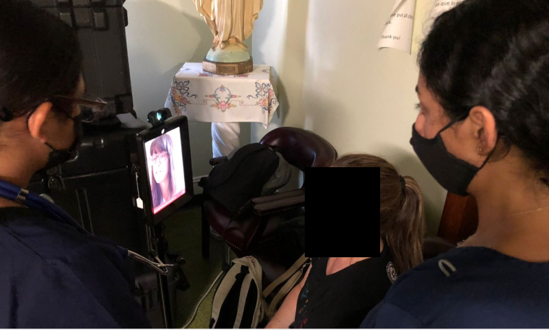 Figure 2. SSSP volunteers and subject communicating with NJMS Department of Ophthalmology ophthalmologist Dr. Miriam Habiel for an offsite live consultation. Dr. Habiel has full access to AI retinal images via telemedicine robot and remote access software.